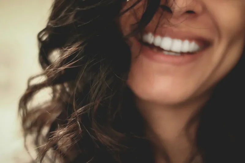 An extreme close-up of a woman's genuine, unguarded smile