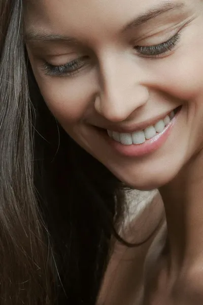 A person with a soft, thoughtful expression