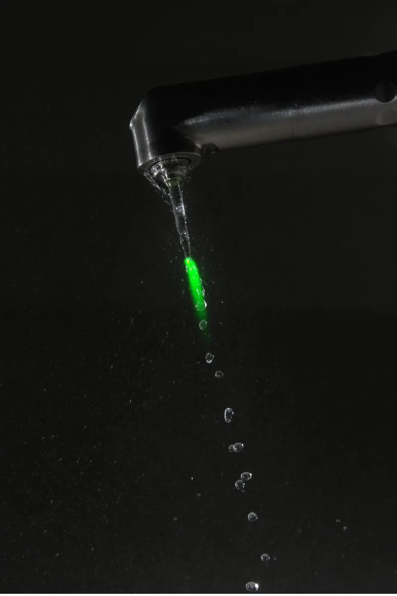 Fotona Nd:YAG laser handpiece with the visible green aiming beam — used to deliver focused energy to teeth during the TouchWhite whitening protocol