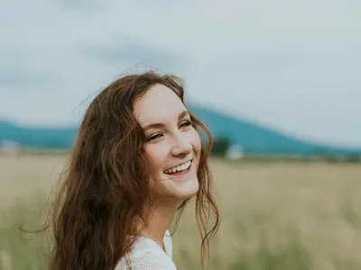 Young woman laughing in natural light