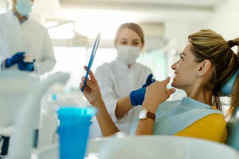 A dentist talking through cosmetic options with a patient in the dental office