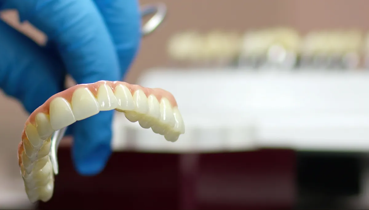 A custom dental crown being crafted in a dental lab