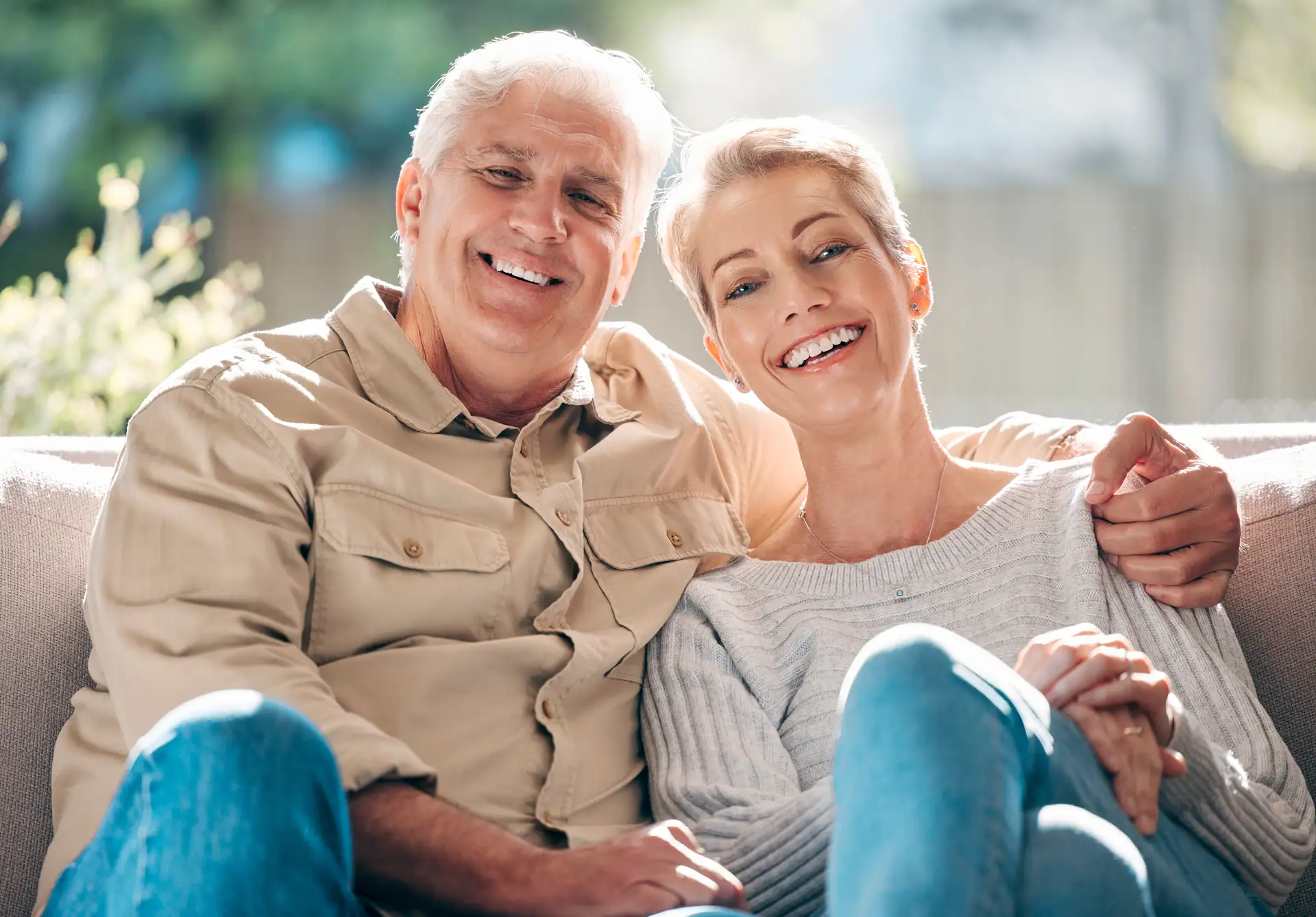 A couple relaxed at home, one of many long-term Magical Smiles patients