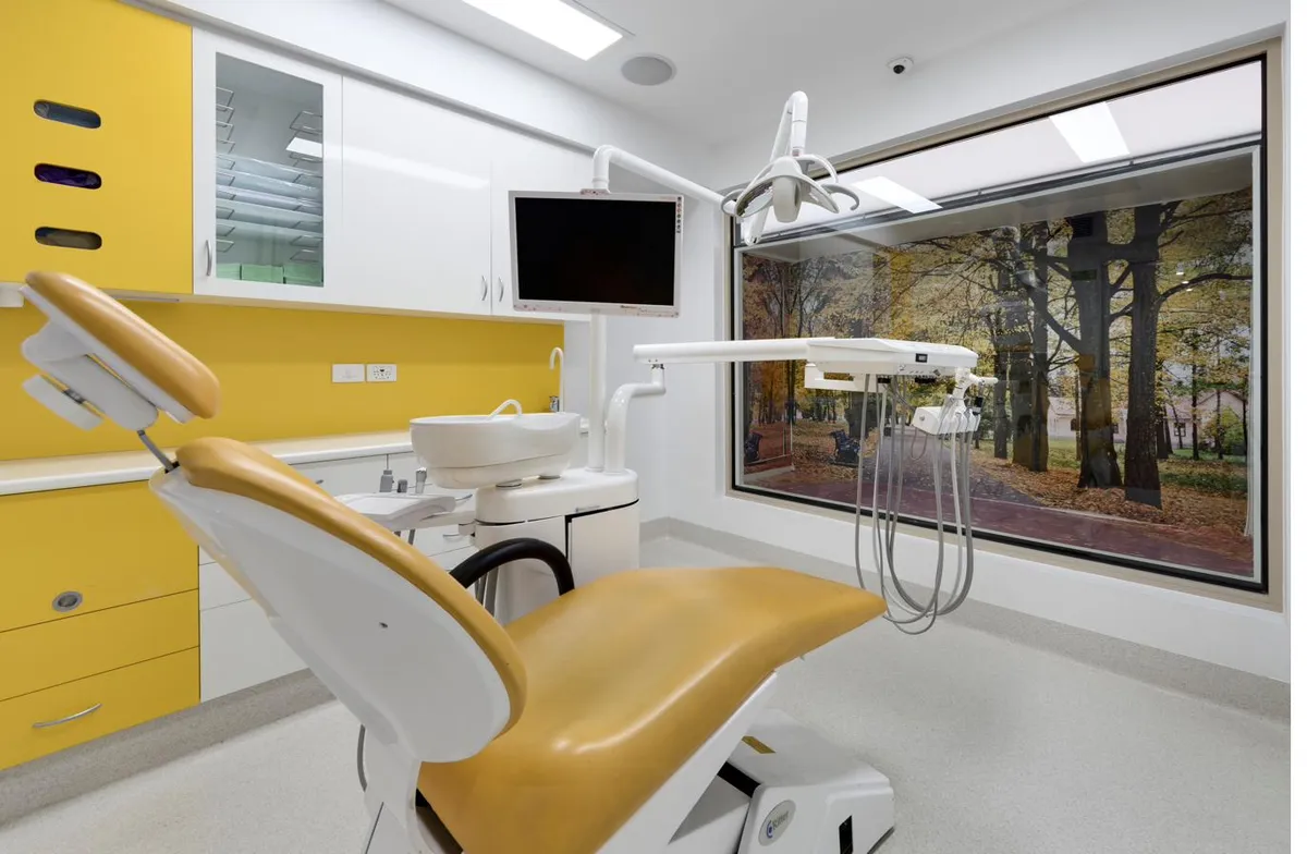 Treatment room at Magical Smiles Caroline Springs with the chair reclined and natural light streaming through the autumn-view window