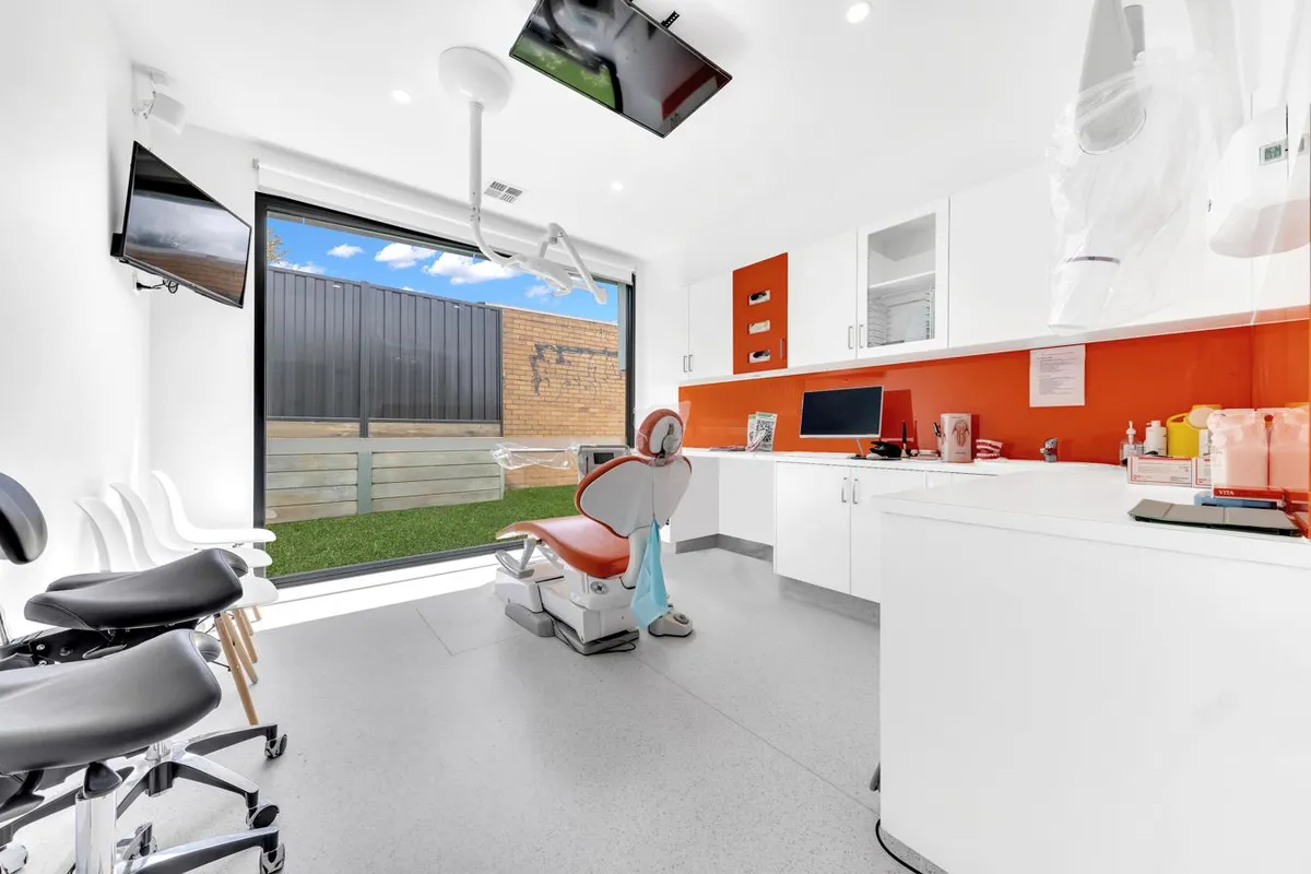 Treatment room with reclined dental chair, natural light, and a calm white interior at Magical Smiles Caroline Springs