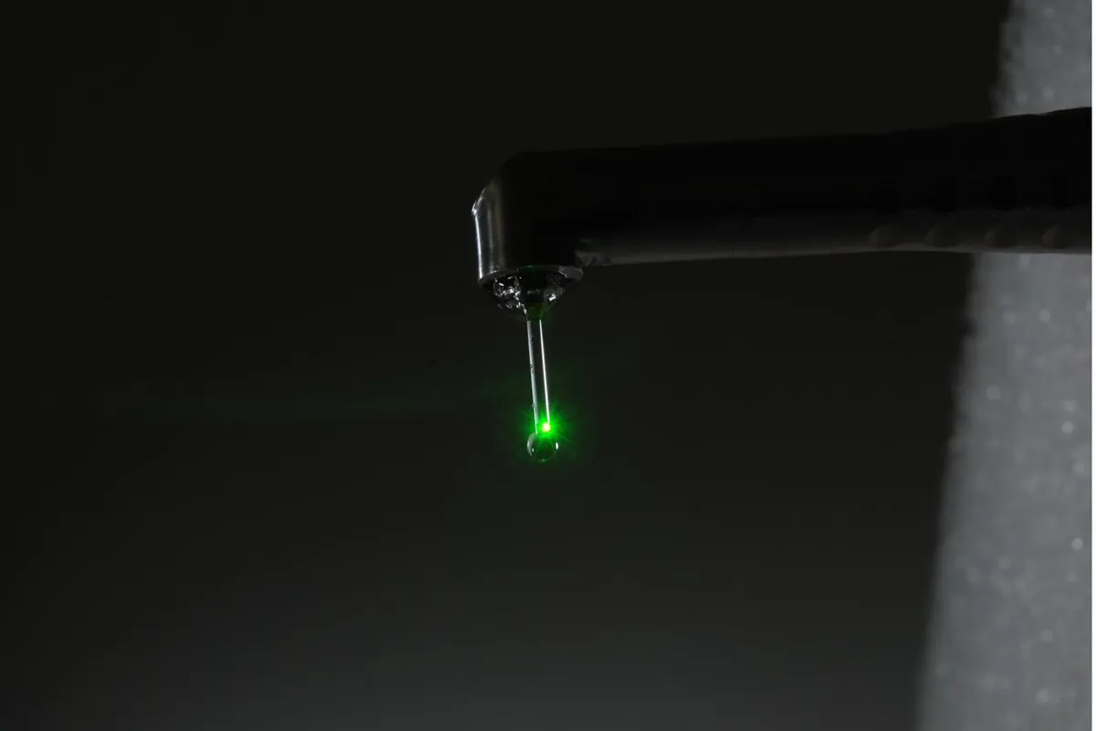 Fotona LightWalker laser delivering a focused green aiming beam — used in laser tooth desensitisation