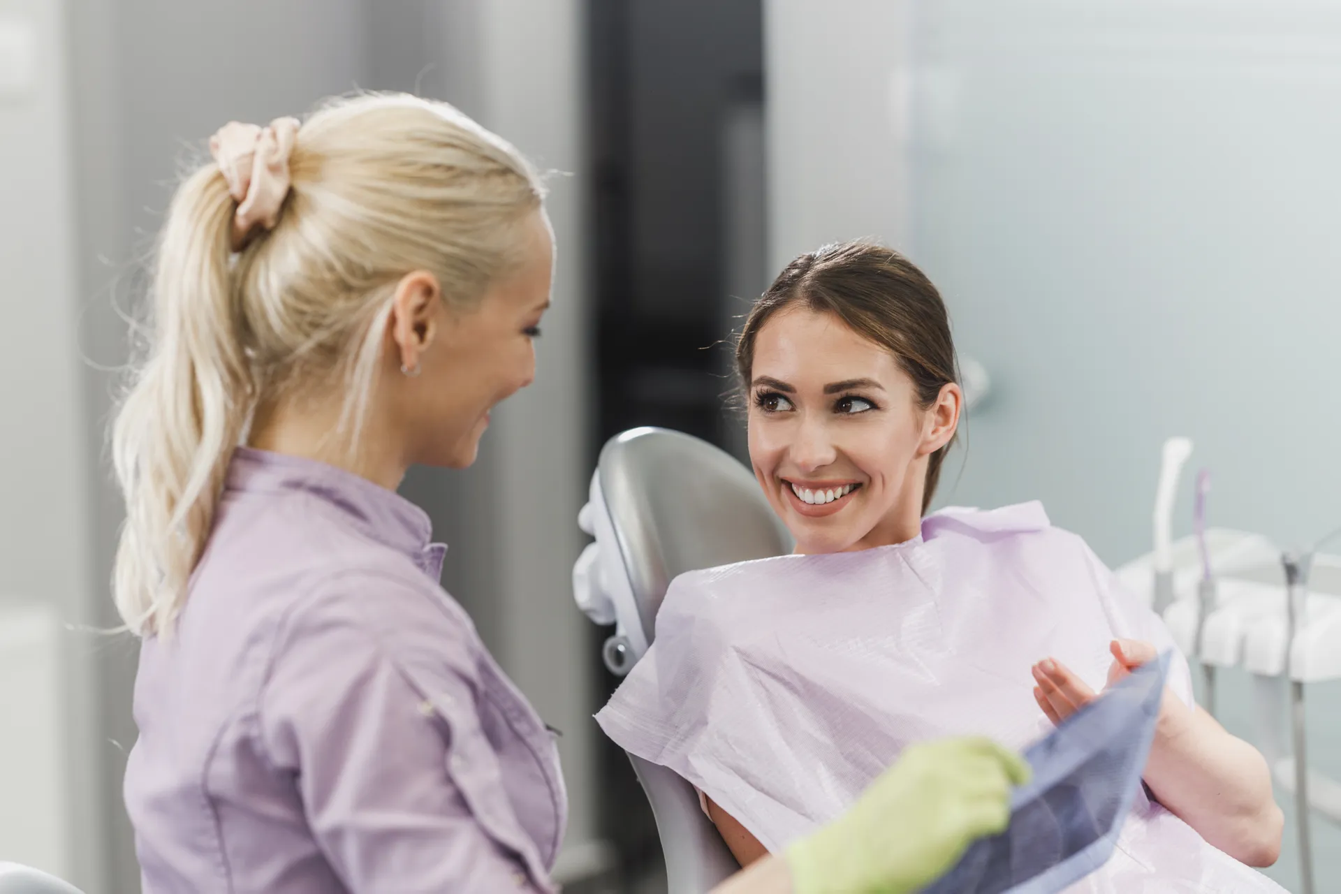Patient smiling and discussing a smile makeover consultation with a Magical Smiles dentist