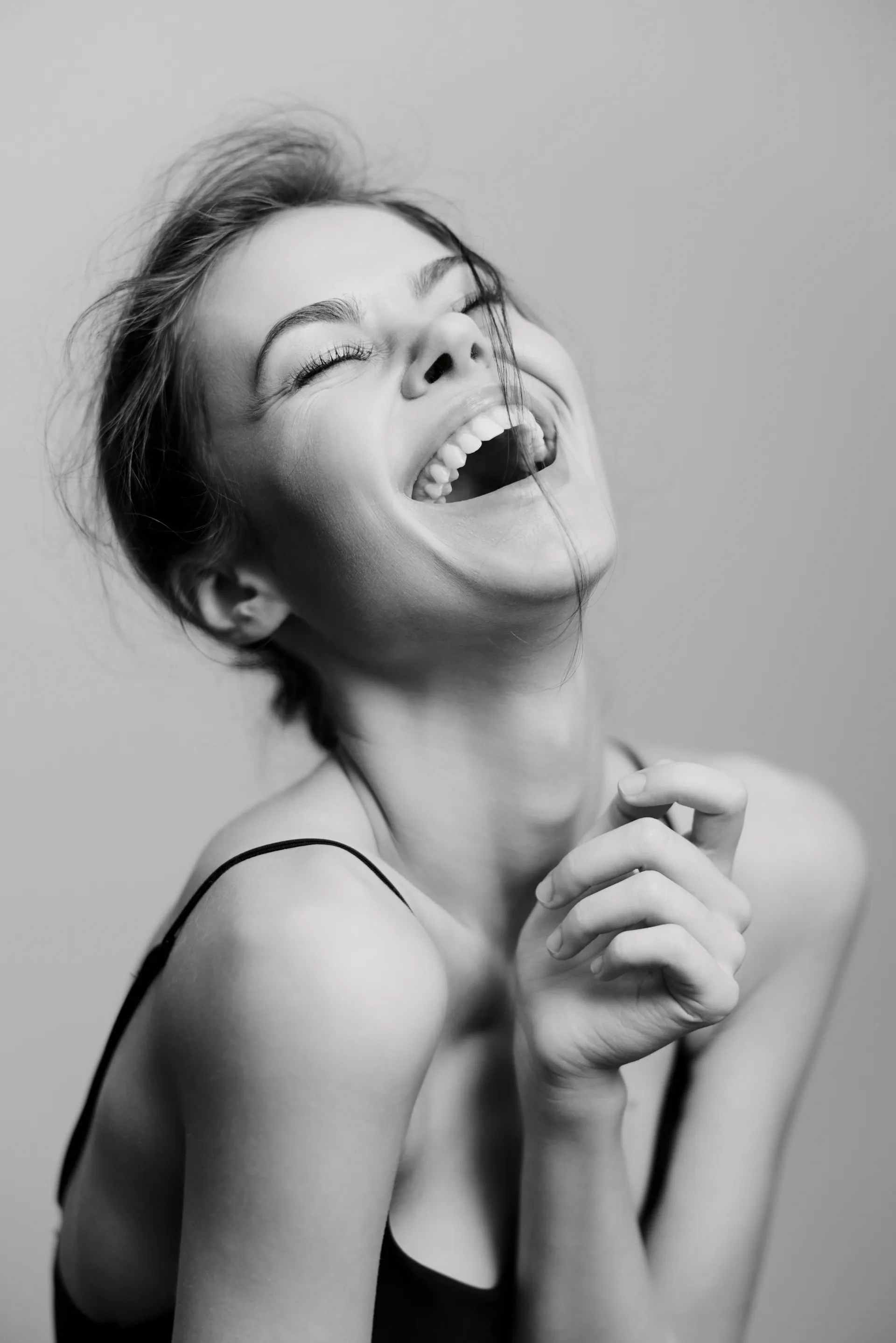 Woman laughing with a bright, white smile